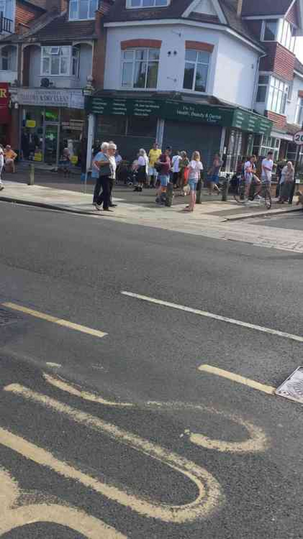 Residents gather outside the cordoned off area