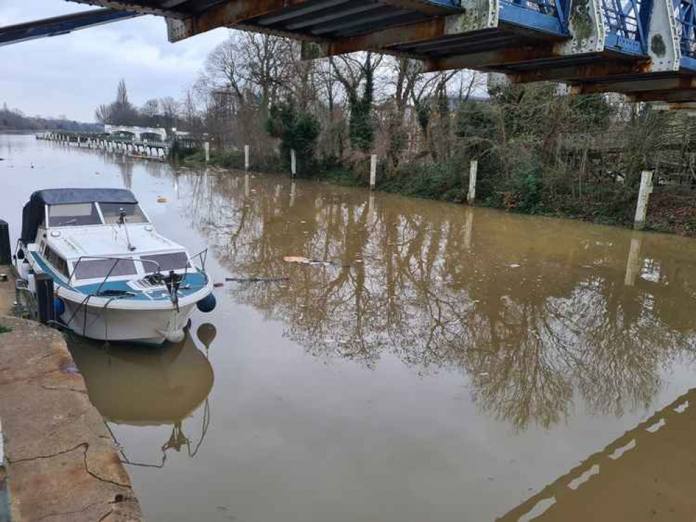 Boat moored underneath the bridge