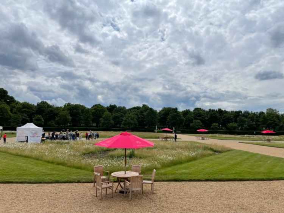 Groups of people gather around the Antiques Roadshow tent - but the usual long queues aren't to be seen (Credit: Jenny Michell)