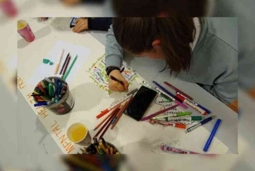 Young people designing the Honiton Mental Health Friendly Town Charter logo at the Thelma Hulbert Gallery Masterpieces Art Group.