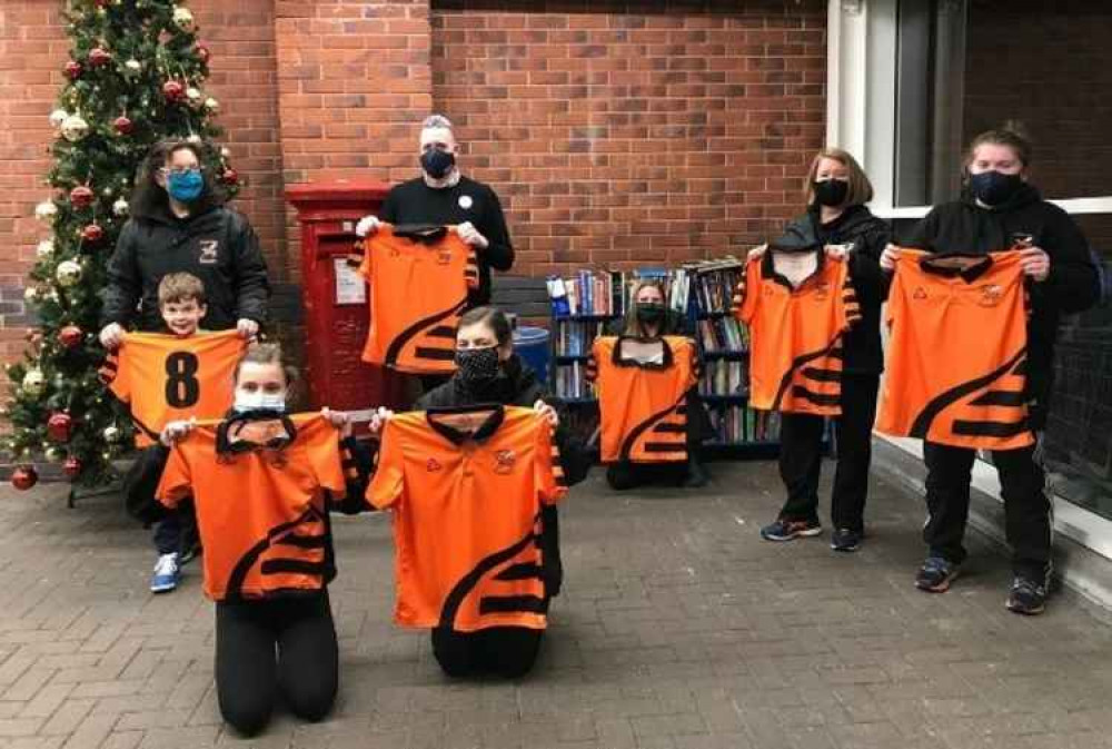 Team members pose with their new shirts outside Tesco Honiton. Back rown(L-R): Amy Phillips with her son Zak, Duncan Sheridan-Shaw (Tesco), Maddy Raynor, Sophie George and Niamh George. Front row (L-R): Hannah Empson and Kathryn Empson