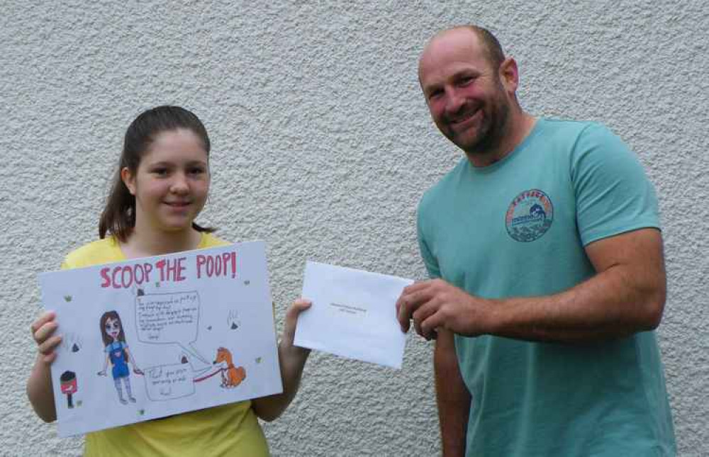 Rosie receiving her prize from Honiton Forward's Jason Hannay