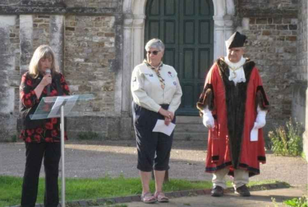 Margaret Lewis talks about the 143 Honiton men killed in the Great War, watched by Helen Turner of 1st Honiton Scouts and Councillor John Zarczynski.