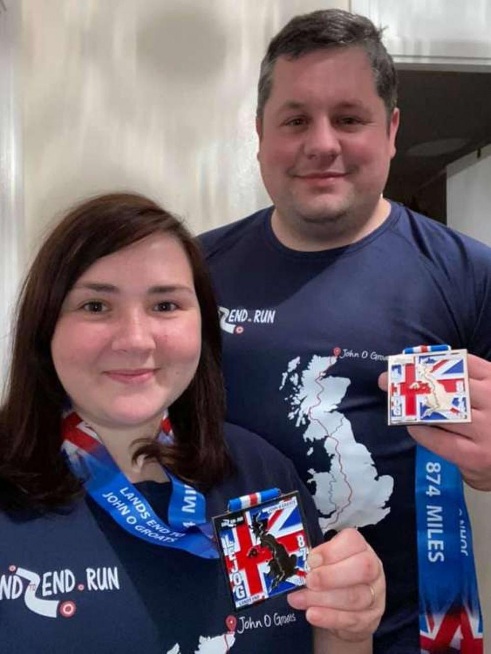 Devon Freewheelers volunteers Amy and Anthony Ewens with their medals after finishing the LEJOG21, a virtual Land's End to John O'Groats 874-mile challenge. Photo credit Amy and Anthony Ewens.