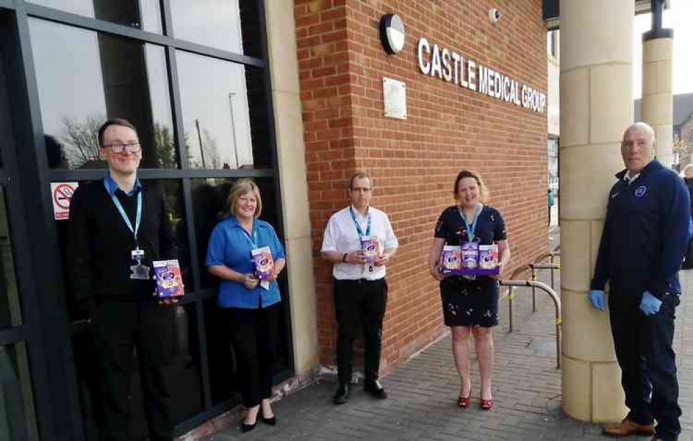 Ashby Ivanhoe's Head of Player Recruitment Gary Timms (right) with Dr John Addison and staff at Castle Medical Centre on Thursday morning