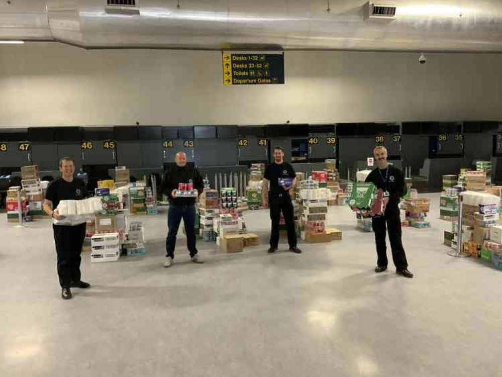 Volunteers from East Midlands Airport fire crew with goods to be donated to foodbanks