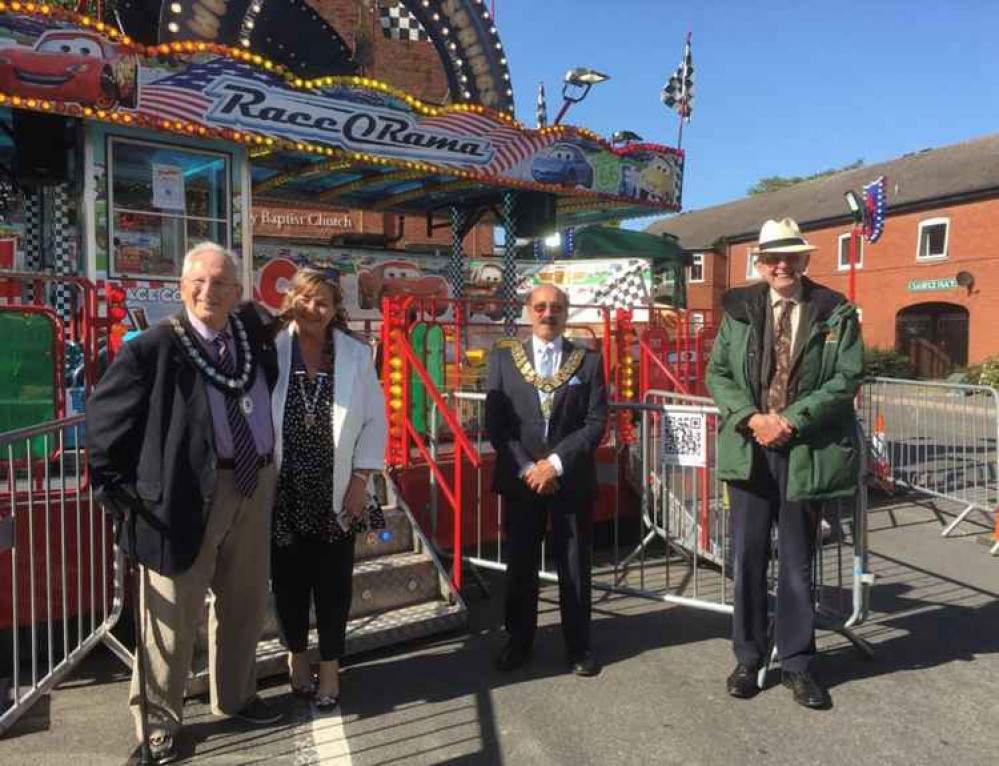 Anthony Harris (right), of Pat Collins Funfair, met Cllr Virge Richichi, Chairman of NWLDC and Ashby Mayor Cllr Graham Allman and his consort (left) outside the children's fair ride in Ashby