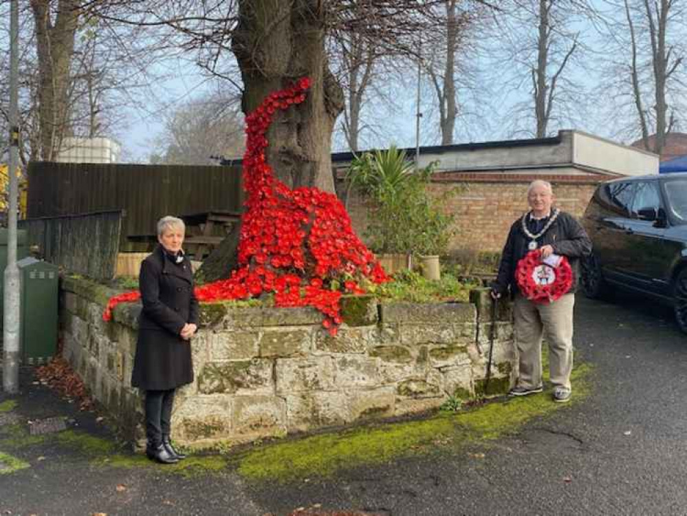 Cllr Allman with Karen Deacon at the Ivanhoe Social Club in front of their poppy display made from plastic bottles