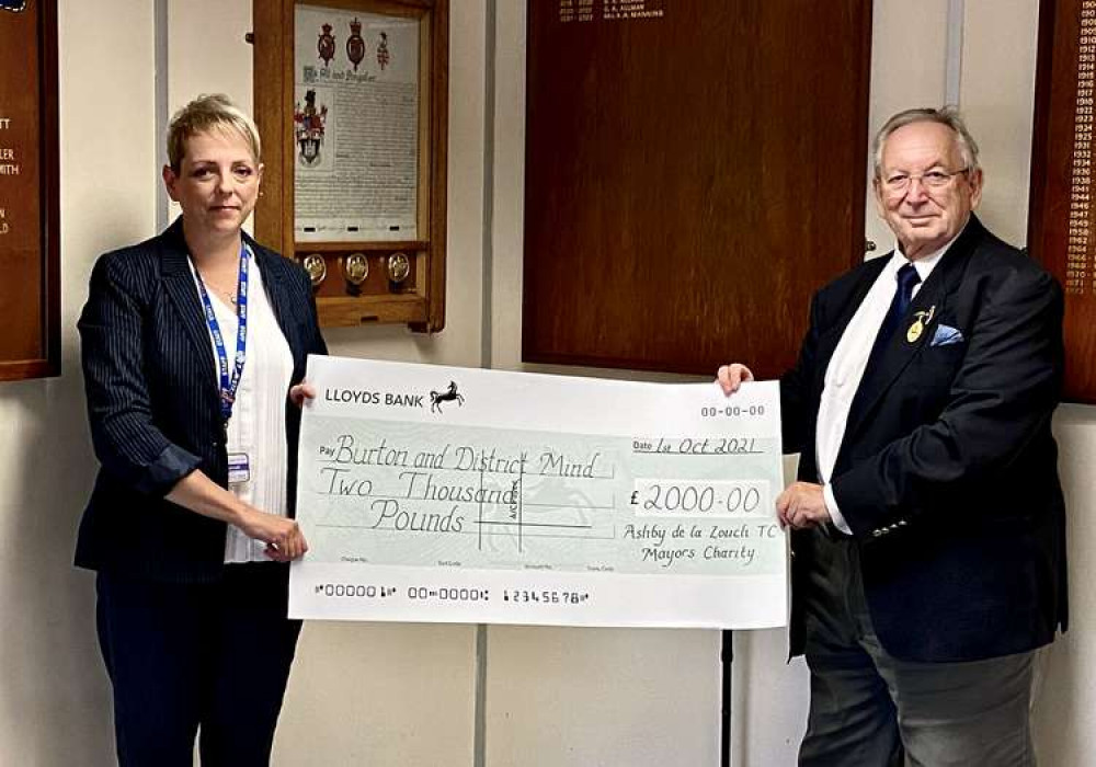 Cllr Graham Allman presents a cheque for £2,000 to Lynne Barrell of Burton & District Mind. Photo: Ashby Nub News