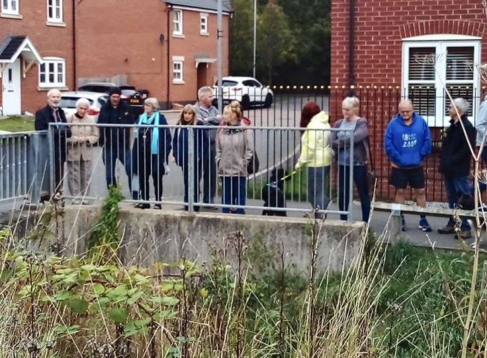 Councillor Dan Harrison (far left) meets Ashby residents in a housing state next to Hood Park to discuss the state of the Brook