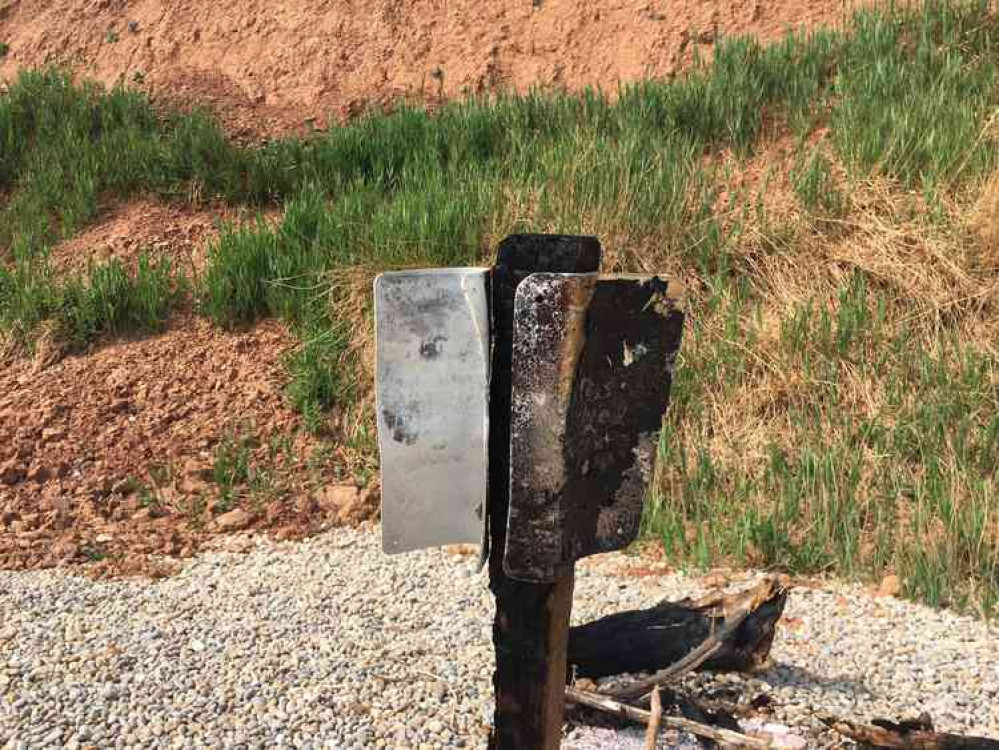 The sign set on fire on Jacobs Ladder Beach. Image courtesy of East Devon District Council.