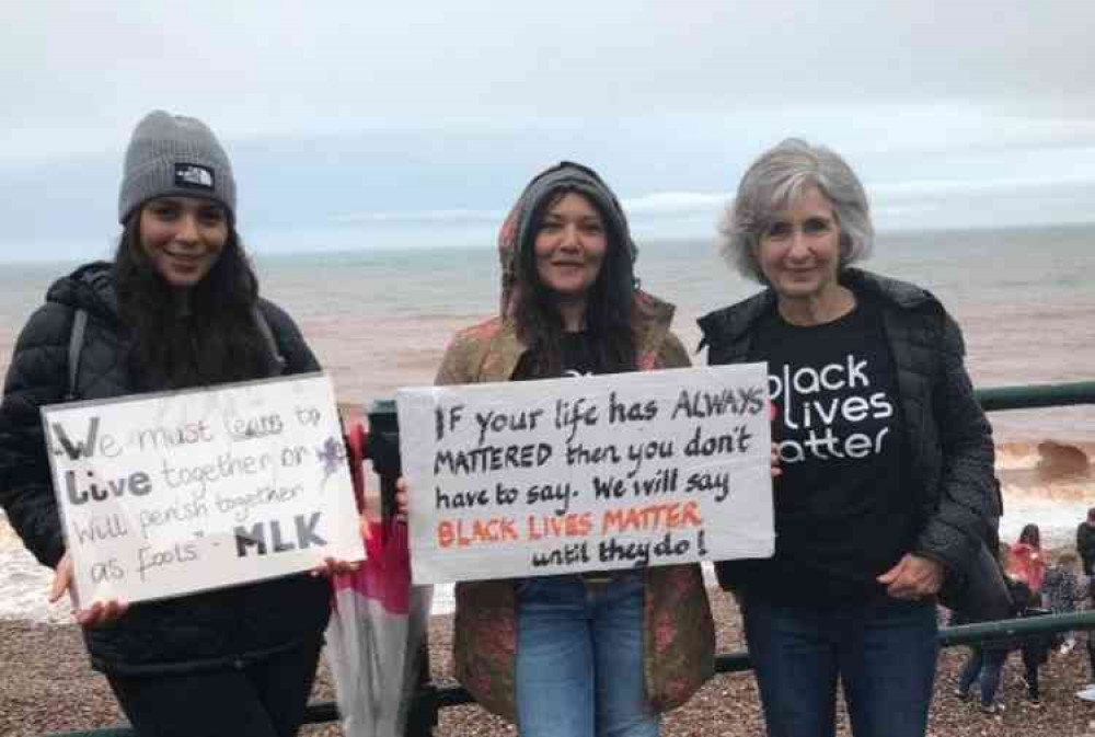 People gathered along the seafront in Sidmouth in a show of solidarity against racism