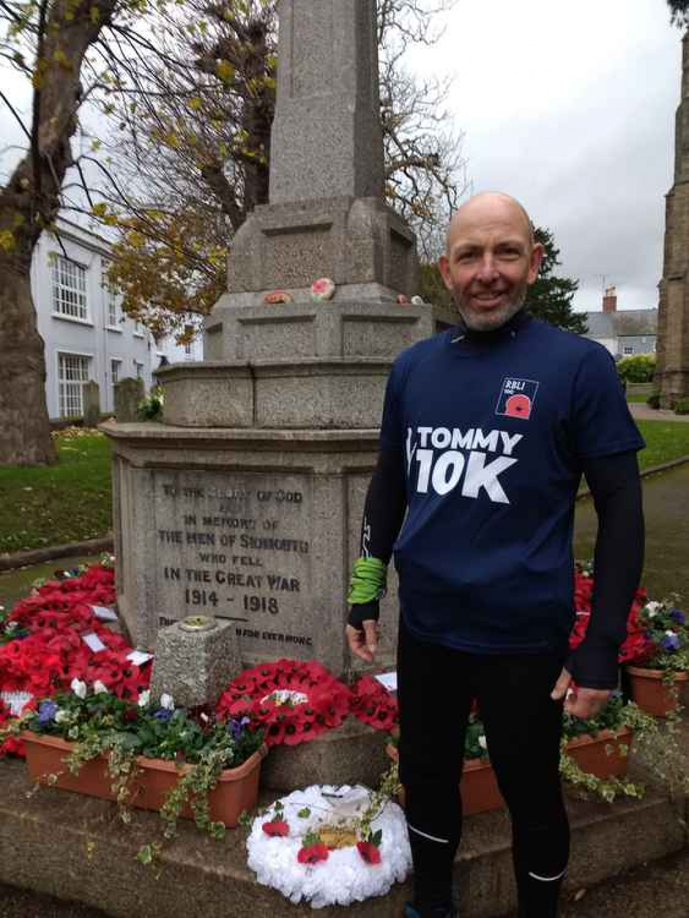 Adrian proudly stands by Sidmouth War Memorial on 11/11/20 having completed 10 consecutive 10k's.