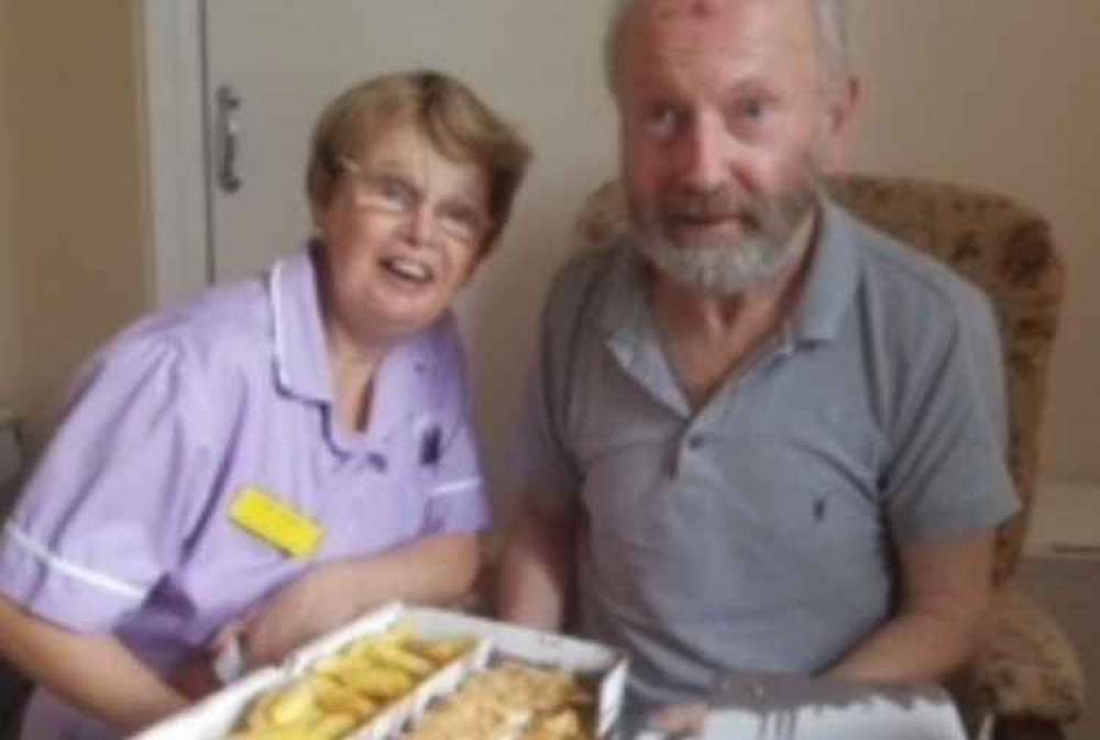 Jane serves takeaway fish and chips to resident