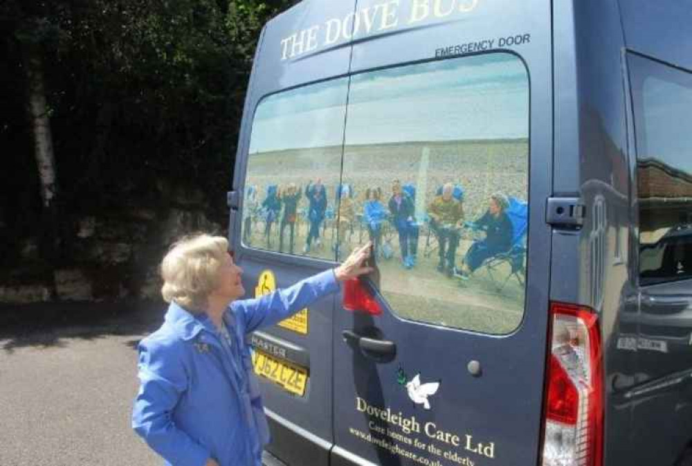 Shirley looks at her picture on the new Dove Bus