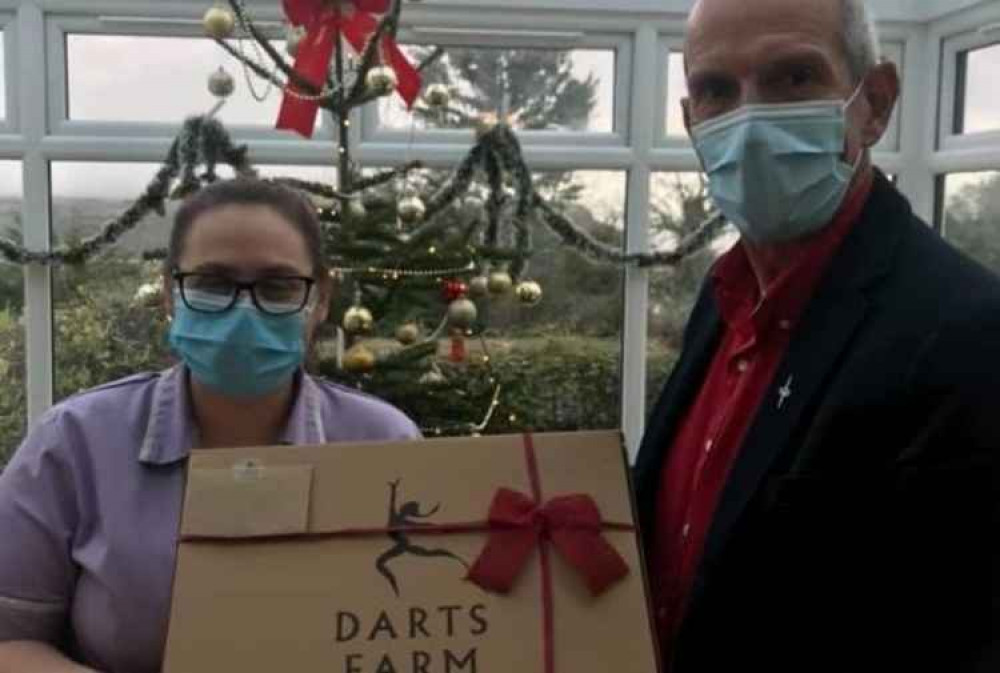 Director Keith Mills presents a hamper to Senior Carer Tania