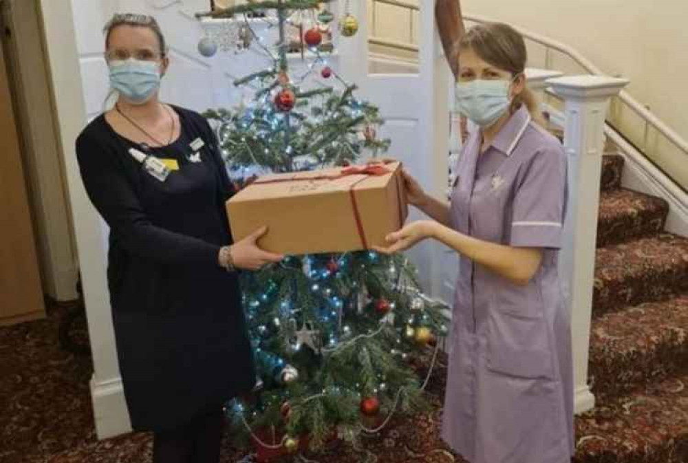 Senior Manager Samantha presents a hamper to Senior Carer Rosie