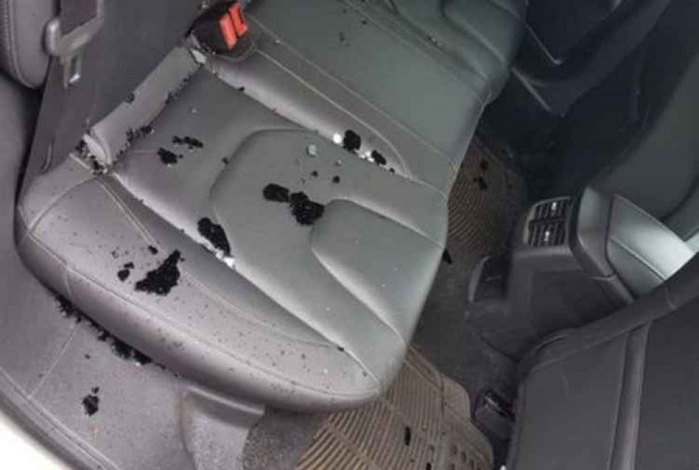 Broken black window glass on the car seat