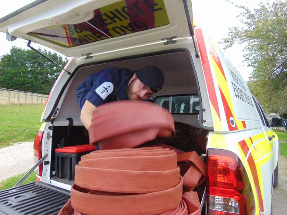 Able Rate Scott Morley removes some of the old fire hoses from the back of his vehicle.