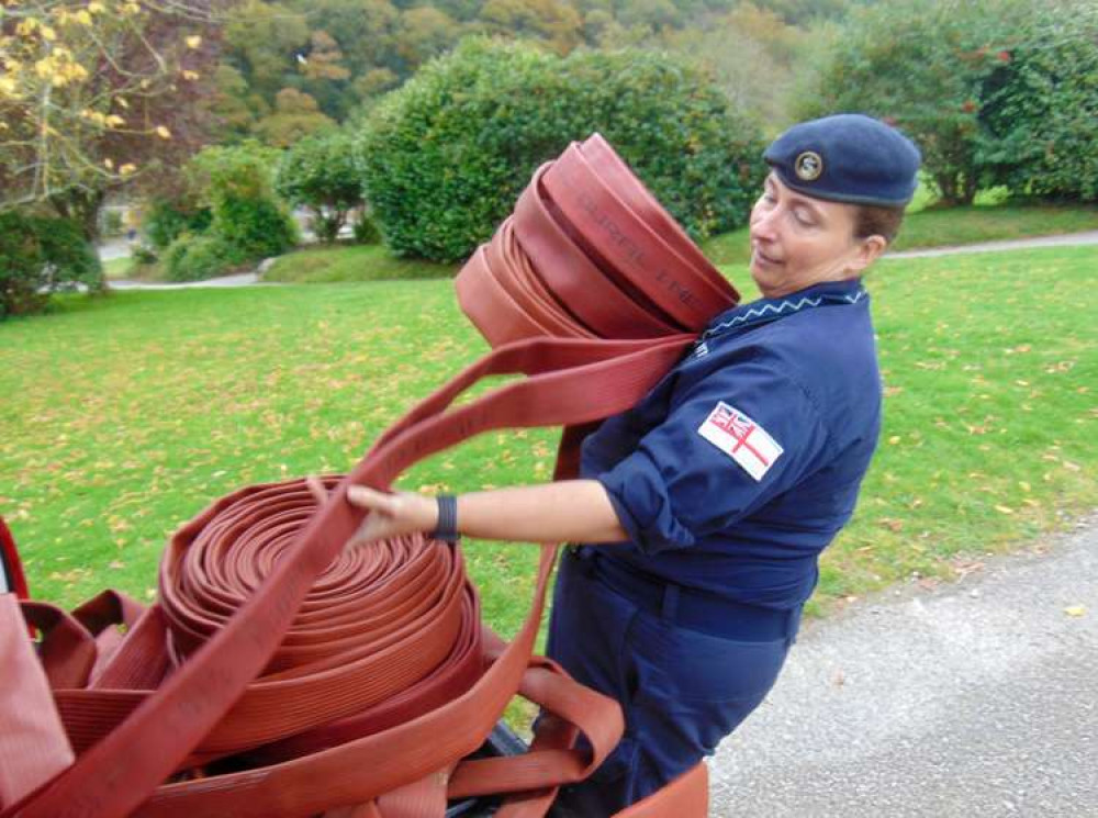 Able Rate Emma Tatnell unloads some of the old fire hoses.