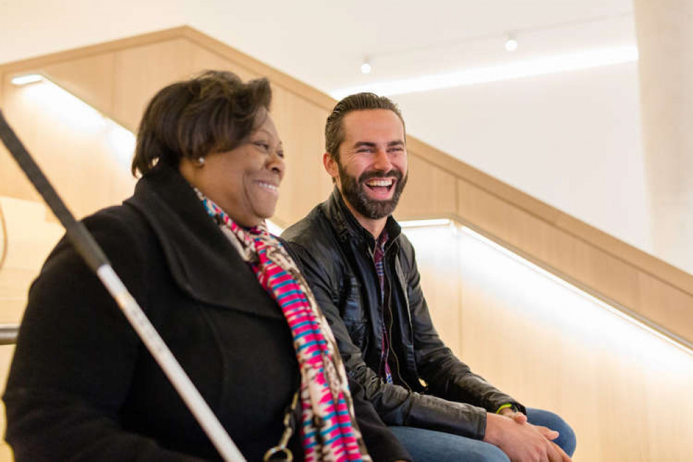 A My Sighted Guide volunteer laughing with their partially sighted partner