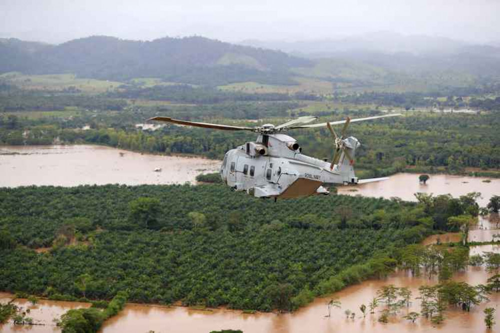 A merlin helicopter flies sorties over a flood Honduras. Credit: Royal Navy.