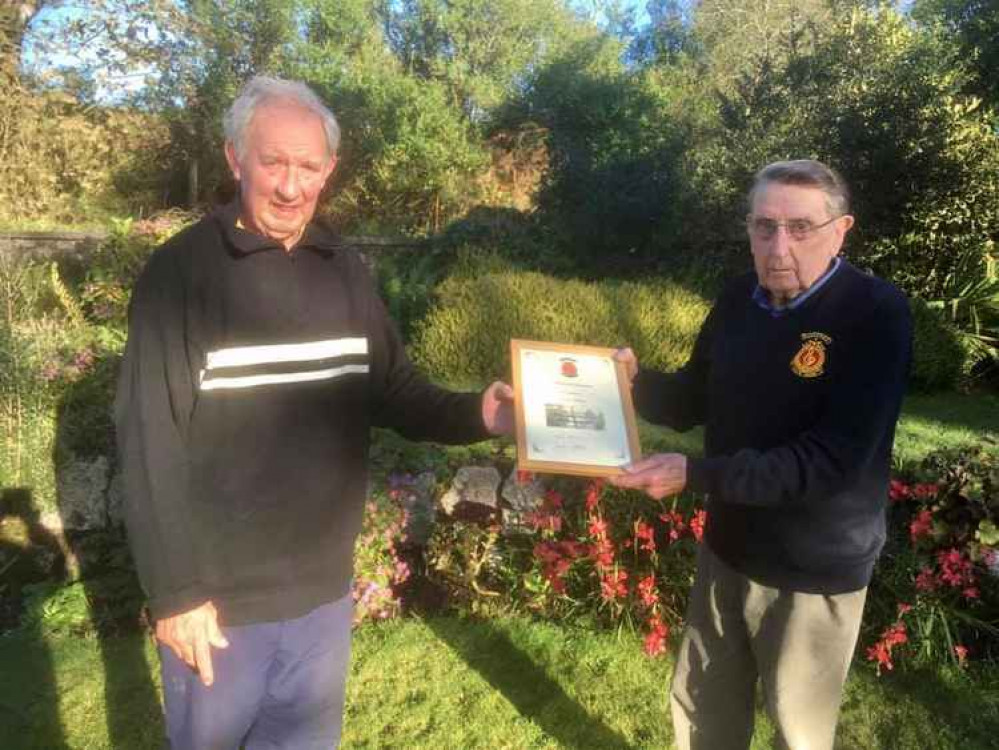 Trevor Williams, receives his certificate for 15 years service from Vice Chairman, Dennis Moses. Credit: Nankersey Male Choir.