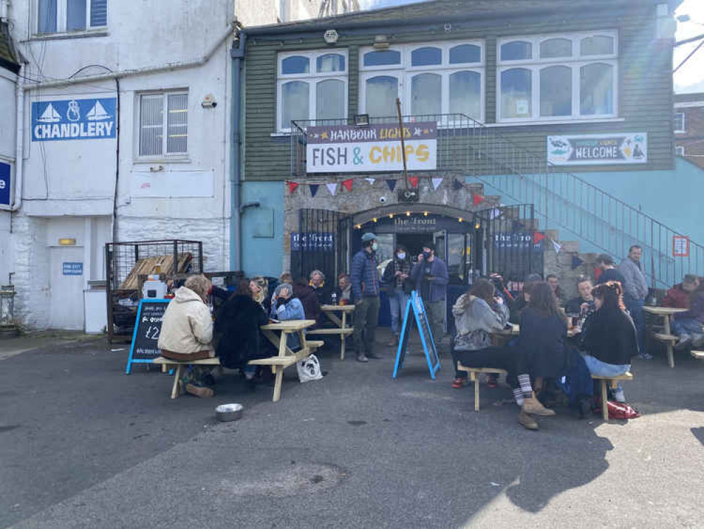 People enjoying the sun outside The Front.