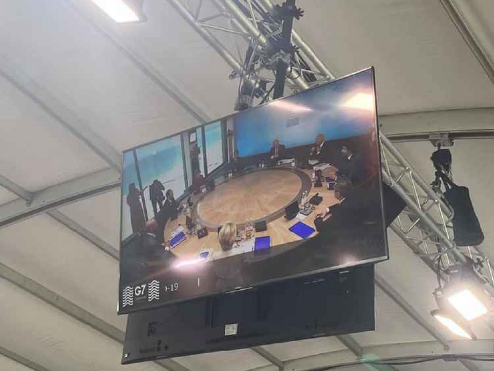 Watching the G7 members seated around the table before their talks earlier.