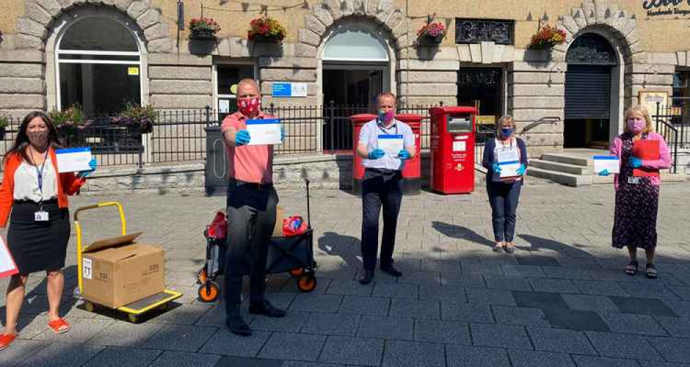 Richard Gates and Richard Wilcox, with members of the Falmouth Town team, handing out covid test kits. Credit: Falmouth Town.