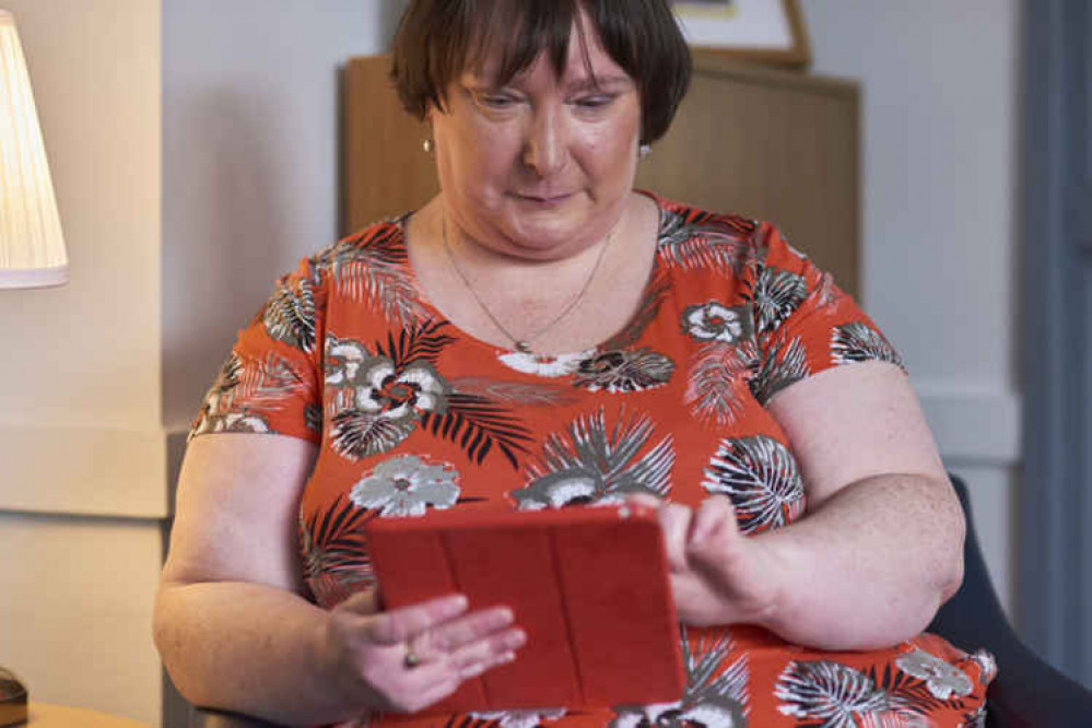 Former Carer's Cafe attendee Sandra Clode on a tablet