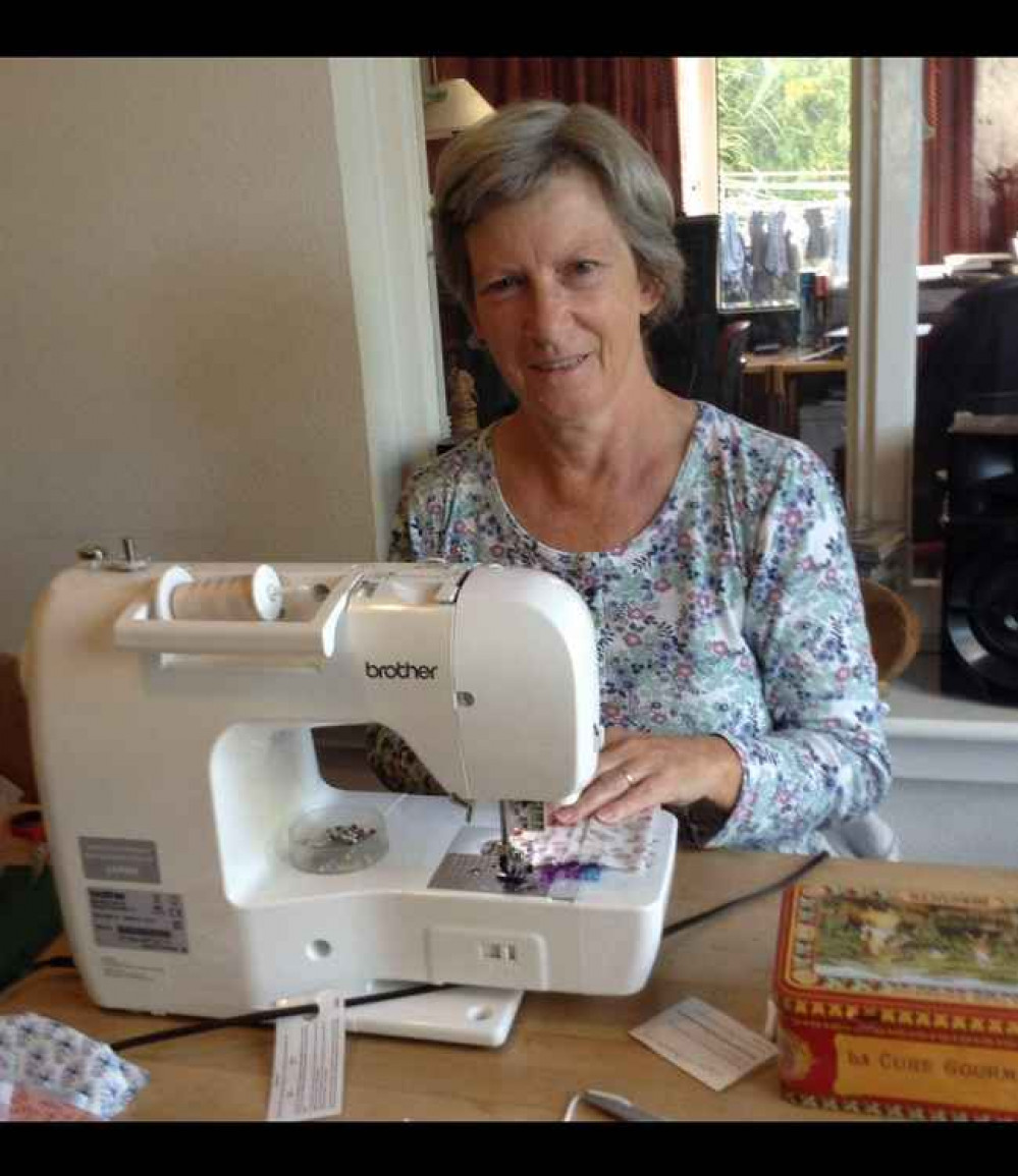 Jenny is one of Helping Hands' "sewing bees" making the masks