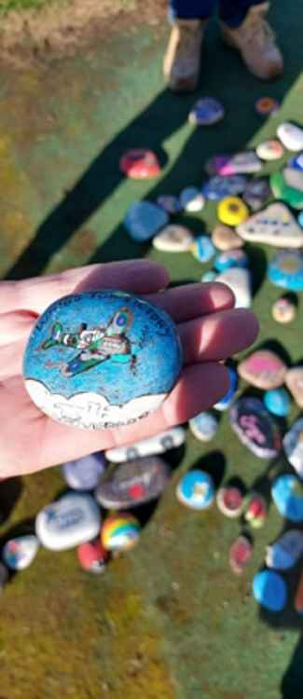 Another stone painted by Margaret Robinson, depicting a spitfire plane