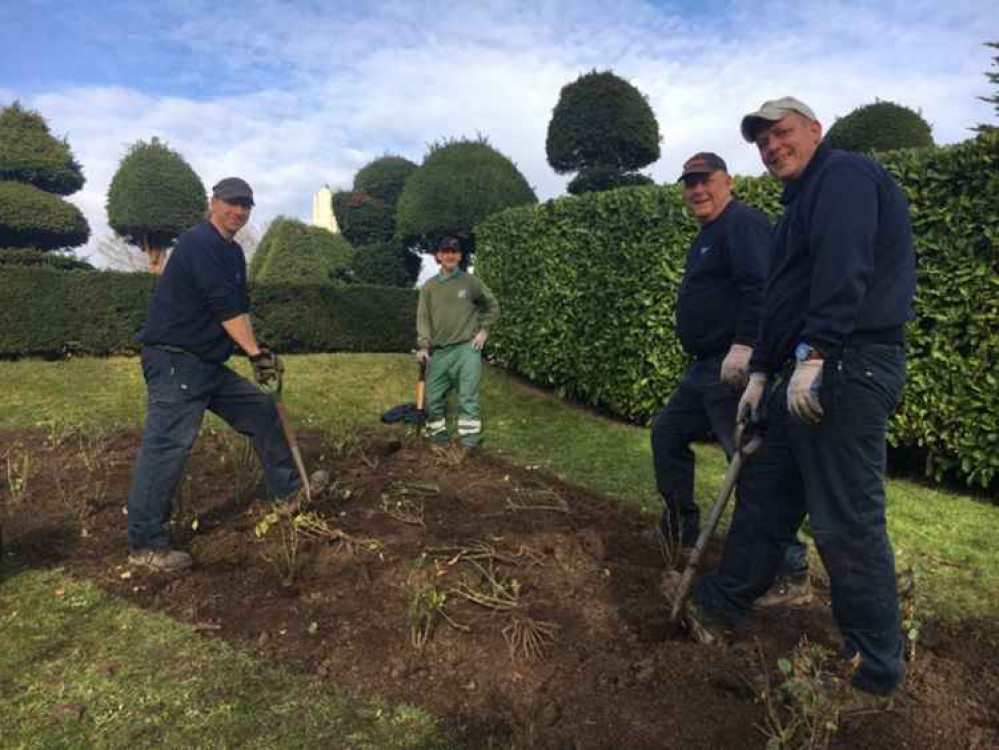 Groundskeepers planting the bushes Barbro provided