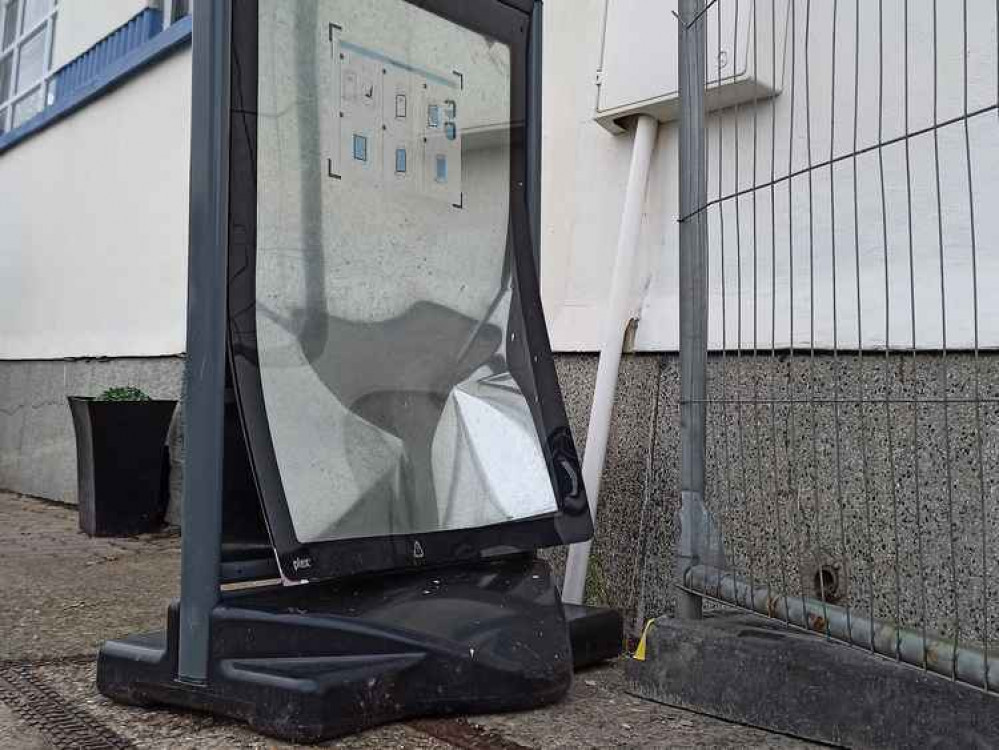 The falling concrete block bounced and damaged Deco's sandwich board.