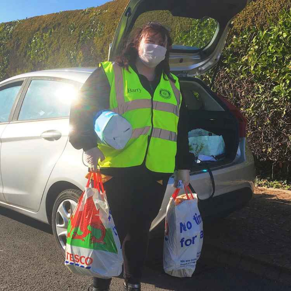 Lynne helping a customer with their shopping back in April 2020