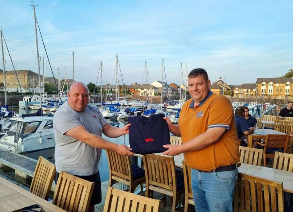 Cliff Taylor being presented his RNLI Guernsey jumper by Lifeboat Operations Manager Jason Dunlop