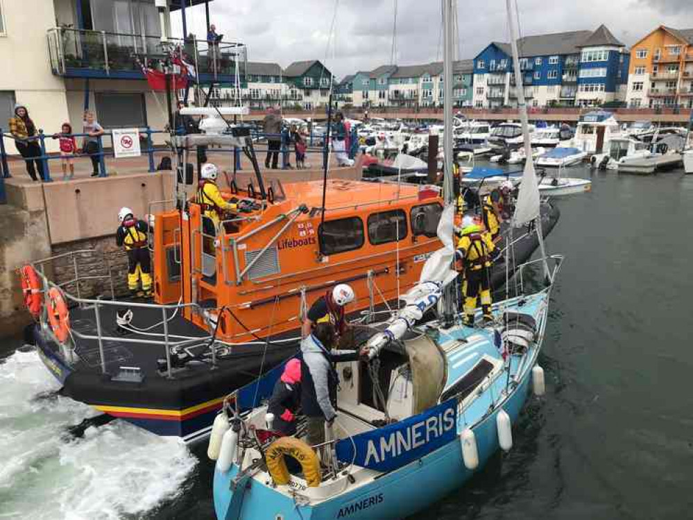 RNLI All Weather Lifeboat R & J Welburn assists the disabled vessel to safety