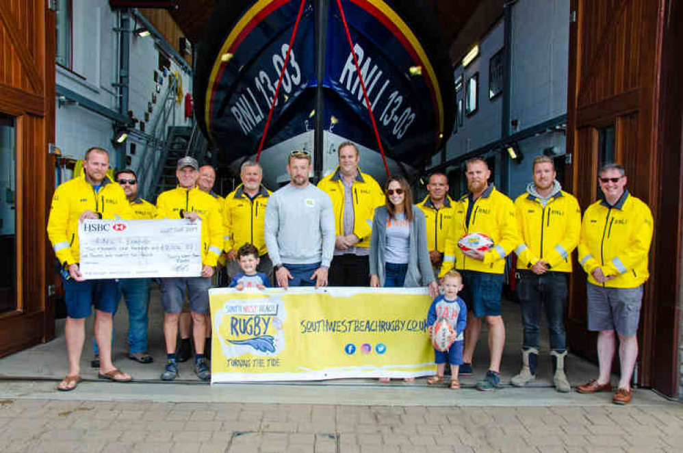Holding Cheque, L – R, Roy Stott, Exmouth RNLI Deputy Coxswain; Steve Hockings-Thompson, Exmouth RNLI Coxswain. Holding banner in front of Exmouth RNLI Crew Members, Matt and Sarah Jess and their two boys Ted and Alfie. Image : John Thorogood / Exmouth Holding Cheque, L – R, Roy Stott, Exmouth RNLI Deputy Coxswain; Steve Hockings-Thompson, Exmouth RNLI Coxswain. Holding banner in front of Exmouth RNLI Crew Members, Matt and Sarah Jess and their two boys Ted and Alfie. Image : John Thorogood / Exmouth