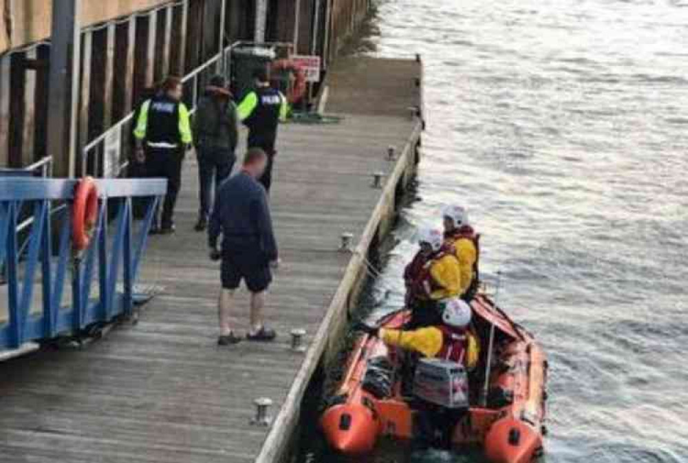 Police speak to those recovered from the vessel. Image courtesy of Rob Vince/RNLI.