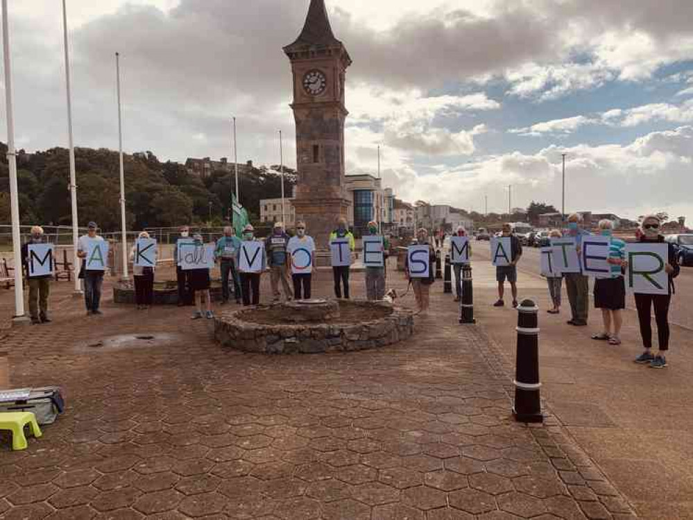 Supporters gather on Exmouth seafront as part of the Make Votes Matter day of action.