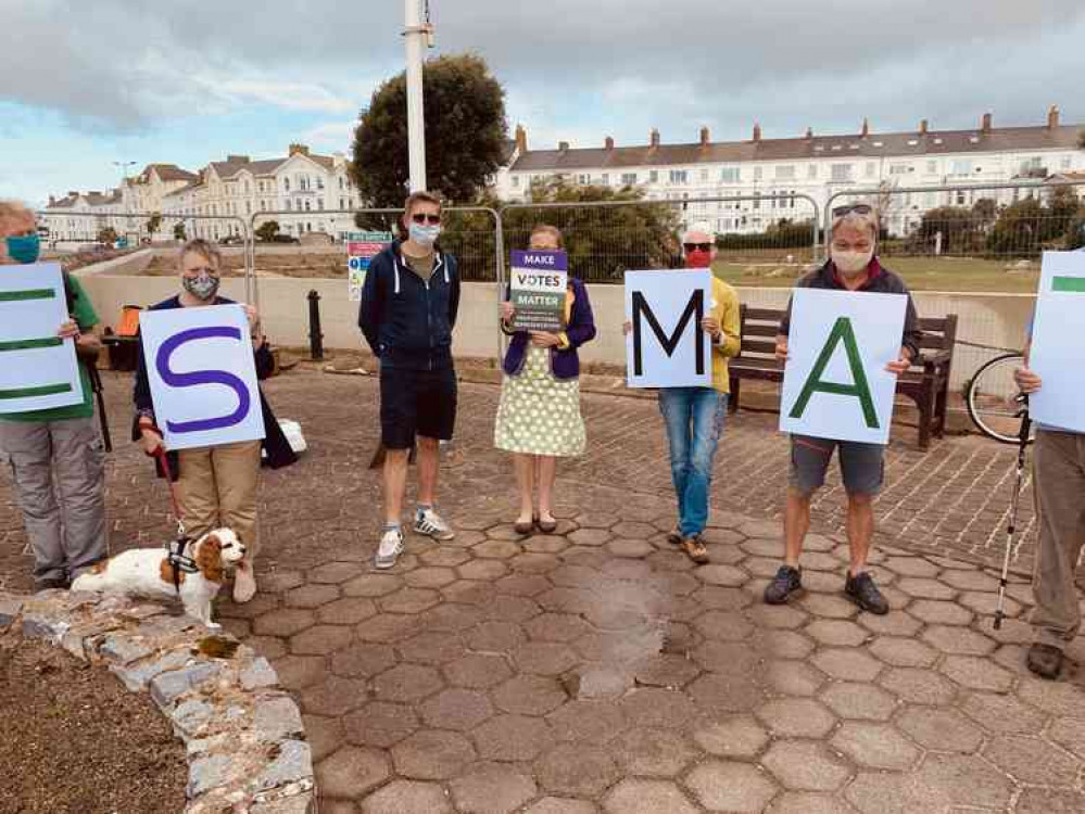 Supporters gather on Exmouth seafront as part of the Make Votes Matter day of action.