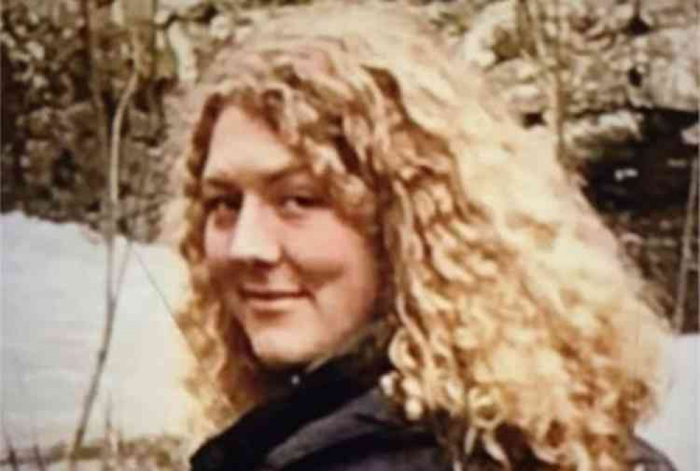 "Julia, pictured, is described as a white female, approximately 5'9" in height, of medium build with strikingly blond curly hair. She was last seen wearing a navy blue polka dot dress and Doc Marten boots."