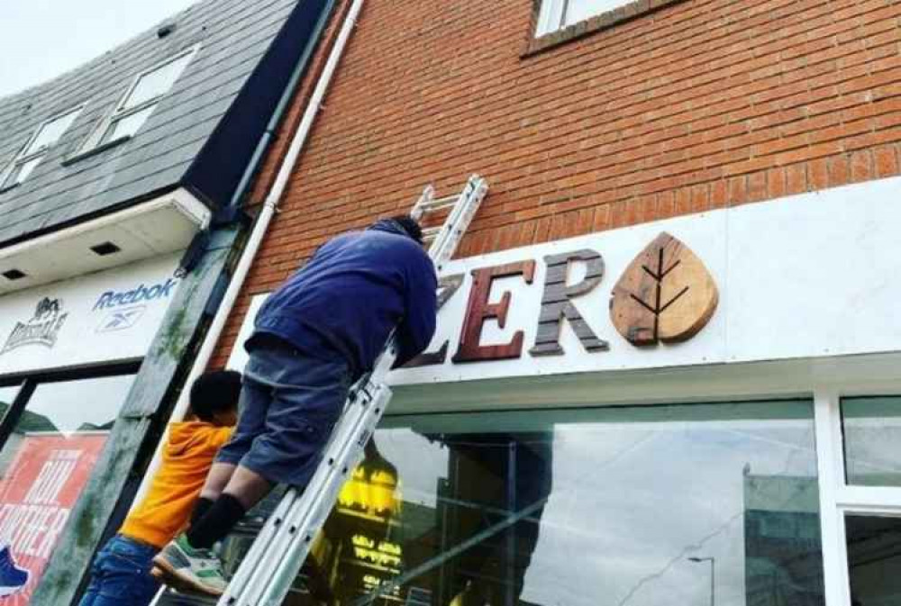 Ernesto working on the shop's exterior