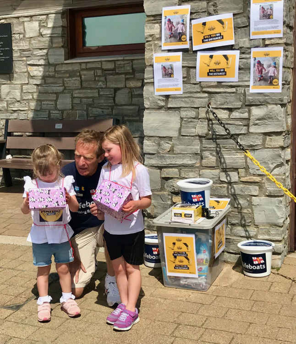 Image: Isla & Ivie receive special gifts from Exmouth RNLI Fundraising Chair, Des White. Credit : Exmouth RNLI