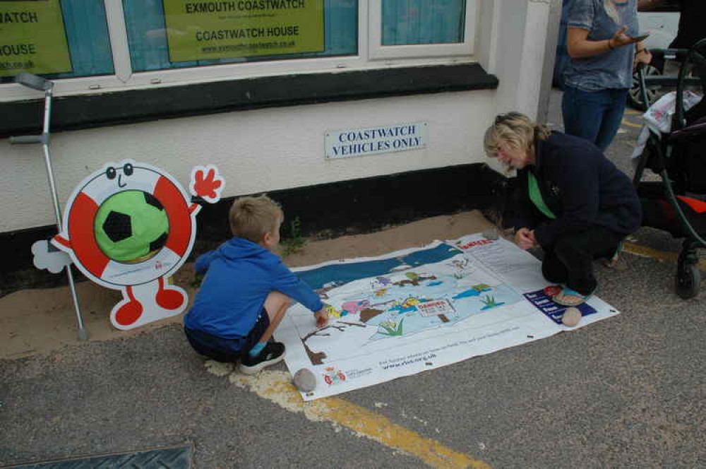 Image: Watchkeeper Karen Goldby discussing hazards with six-year-old Rory from Pinhoe. Credit: David Wright