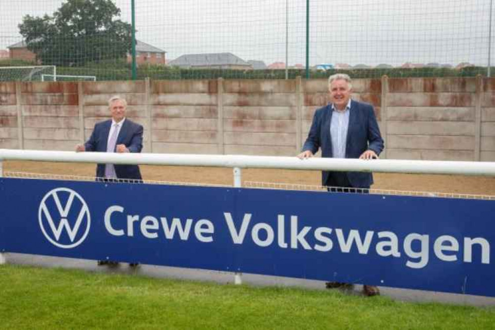 David Smyth and Jon Gold in front of Crewe Volkswagen sponsor board.