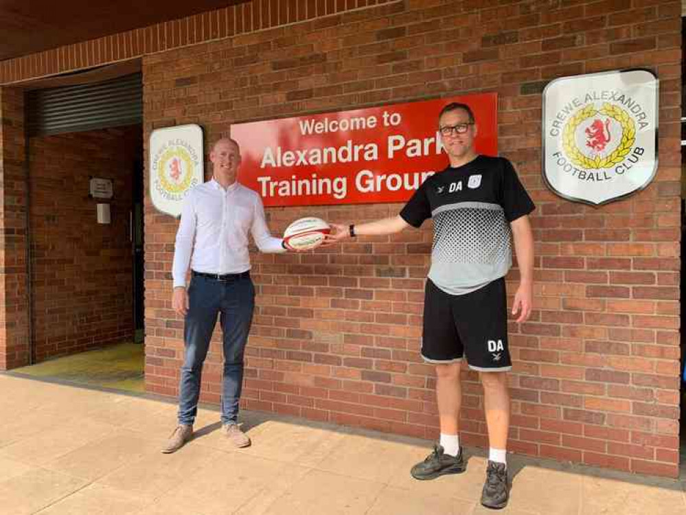 Kieran Mullan presents a signed rugby ball from Crewe and Nantwich Rugby Club to Dave Artell