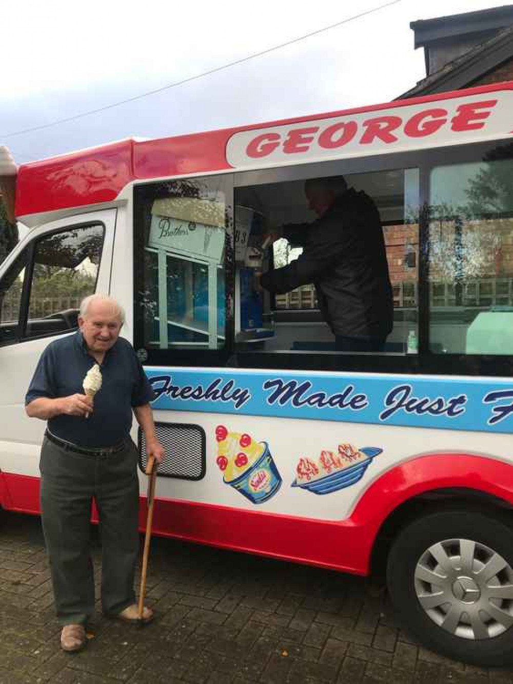 George tucks into an ice cream. George tucks into an ice cream.