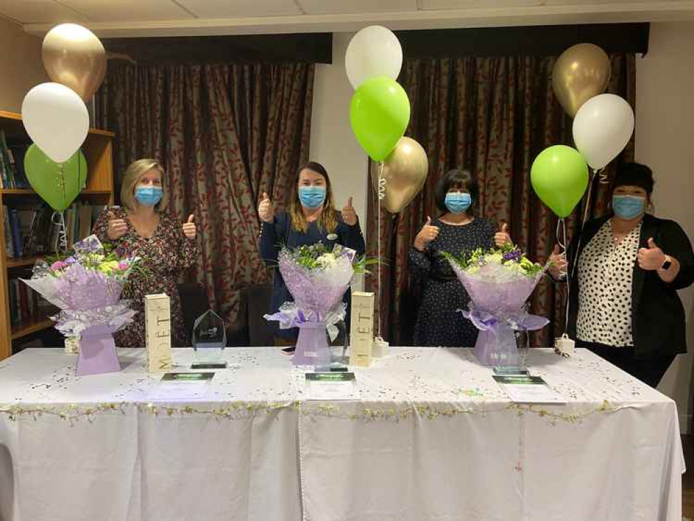 Colleagues at Belong Crewe with their awards and prizes. Colleagues at Belong Crewe with their awards and prizes.